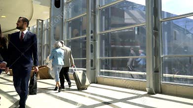 Two seniors walking with suitcase