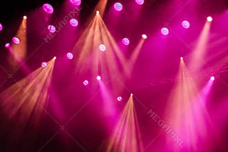 Lighting equipment on the stage of the theatre during the performance. The light rays from the spotlight through the smoke