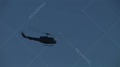 Military Huey hu1 helicopter flying in blue sky many shots