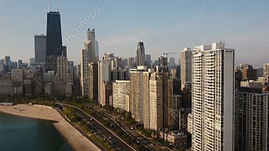 Aerial view of the Chicago, America on the down. Drone flying away from the downtown on the shore of Michigan lake.