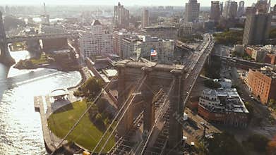 Aerial view of the Brooklyn bridge and district in New York, America. View of the flag waving on wind and East river.