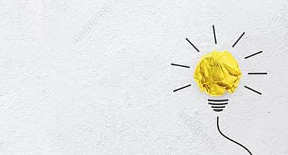 Ideas with yellow paper crumpled ball on wall background