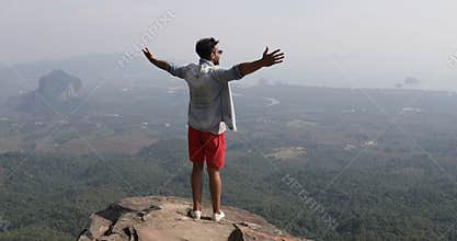 Man On Mountain Top Raise Hands Looking At Beautiful Landspace Back Rear View Of Male Tourist