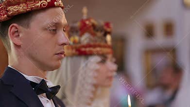 Bridal couple in church on wedding day close-up.