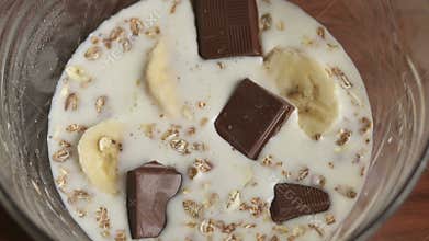 Girl puts a plate of oatmeal chocolate chips.