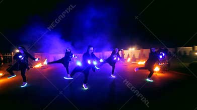 Fireworks. Fire show. Boys and girls dance in shoes that glow in the night
