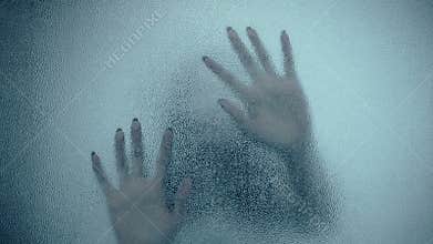 Female hand and head, spooky shadows on the glass wall, in full HD, Horror movie scene