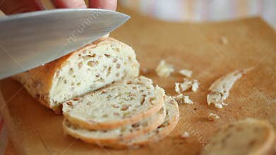 Homemade Bread slicing onto thin slices using sharp knife