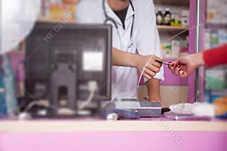 Client is paying with credit card for pills in pharmacy