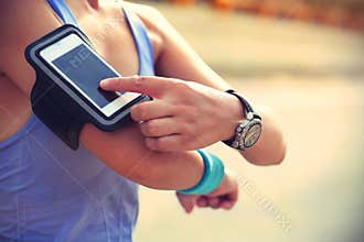 Runner athlete listening to music from smart phone mp3 player smart phone armband