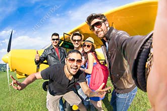 Best friends taking selfie at aeroclub with ultra light airplane