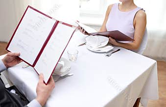 Close up of couple with menu at restaurant