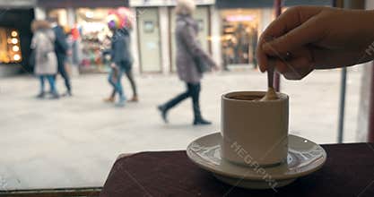 Woman having coffee by the window in cafe