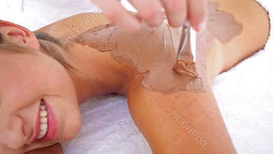 Beautiful brunette enjoying a chocolate beauty treatment