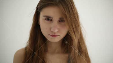 Unhappy sad teenage girl isolated at white background