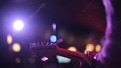 Man playing electric guitar on a stage