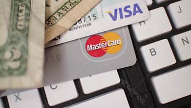 ECOMMERCE - 60fps slow motion dolly rotate back over arrangement of bills and cards.