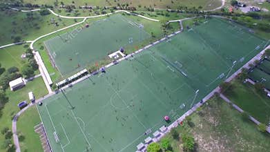 Areal view of soccer fields with people playing.