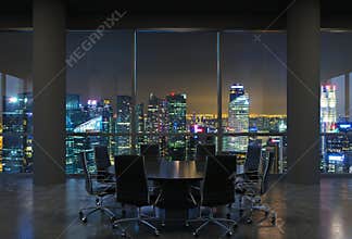Panoramic conference room in modern office, cityscape of Singapore skyscrapers at night. Black chairs and a black round table.