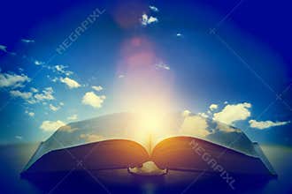 Open old book, light from the sky, heaven. Education, religion concept