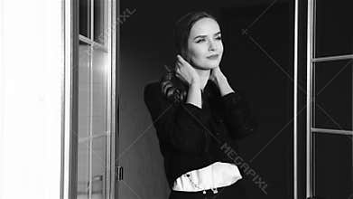 Beautiful young woman with blond hair coming out of the door flirting shy sends kiss breathe air free air, perfume, cosmetics