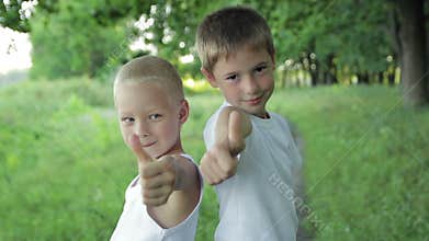 Two boys close-up shows the thumb