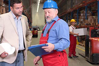 boss + old worker in warehouse