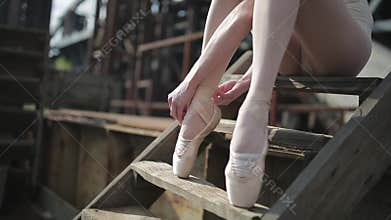 Video footage close-up of a ballet dancer tying