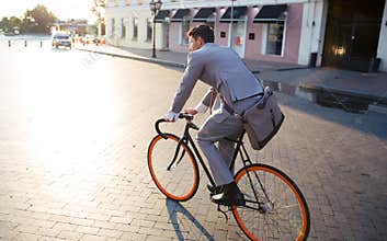 Businessman riding bicycle to work