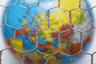 Global map behind a wire fence