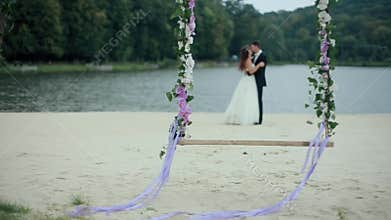 Wedding Bouquet on Seesaw with Married Couple