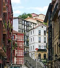 City landscape of a small, cozy street with cascaded houses in Bilbao