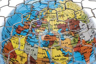The global map behind a wire fence