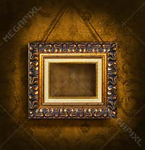 Gold picture frame on antique wallpaper