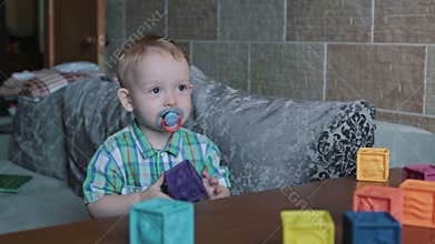 A kid playing toy blocks