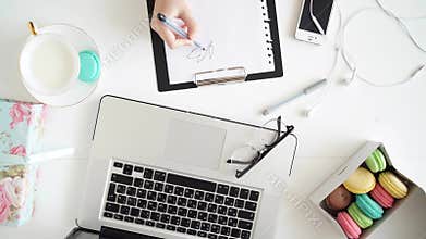 The female hands writing against fashion woman objects