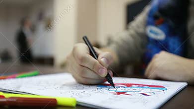 Man paints coloring box pages