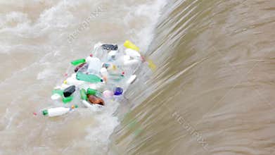 Plastic bottles float in a waterfall