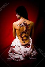 Young woman with dragon tattoo