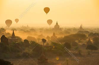 Balloons fly over thousand of temples in sunrise in Bagan, Myanmar