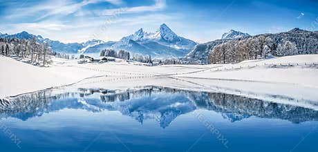 Winter wonderland in the Alps reflecting in crystal clear mountain lake