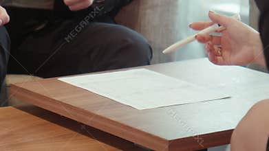 Business male and female sign paper