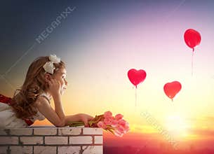 Girl looking at red balloons