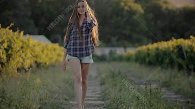 Lovely girl dressed in a shirt and shorts walking