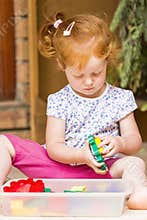 Toddler girl playing toys