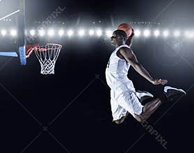 Basketball Player scoring a slam dunk basket