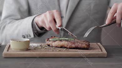 A Young Man Eating a Steak