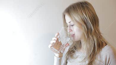 Blonde woman drinking water