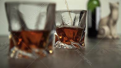 Pouring whiskey in two glasses
