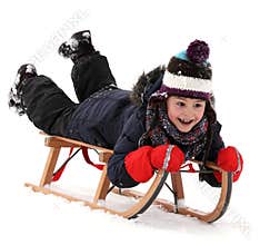 Happy child on sledge in winter, winter sports